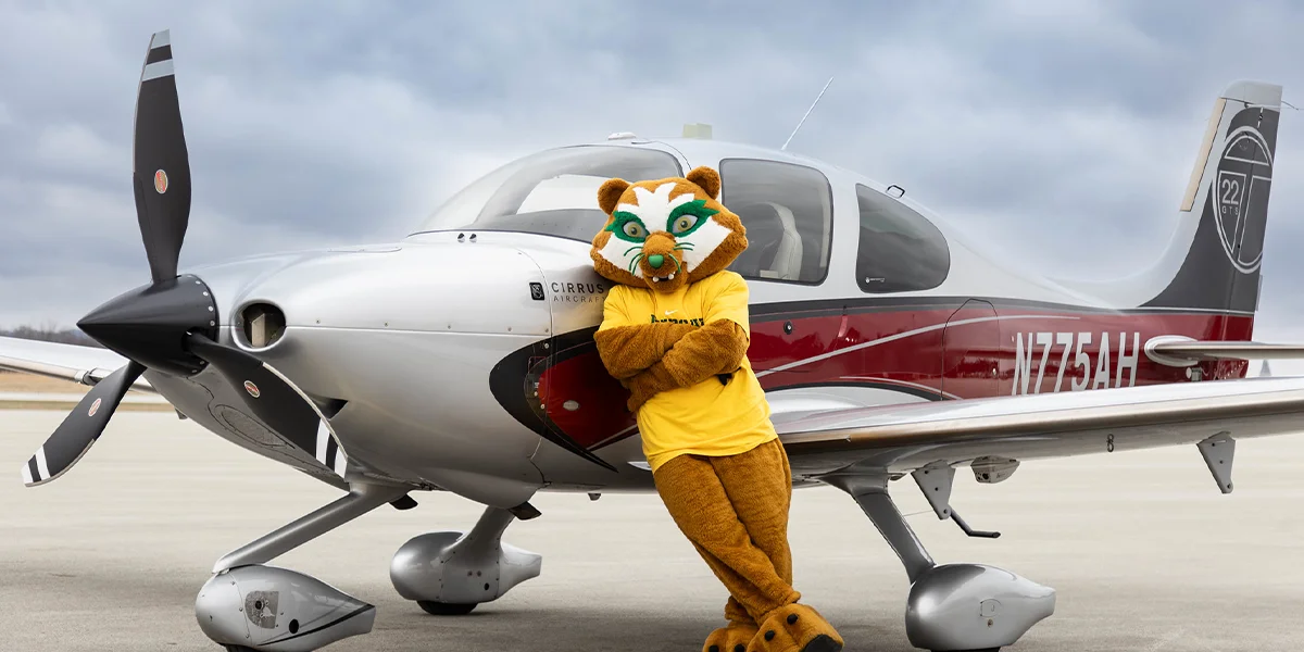 Vinny standing next to airplane