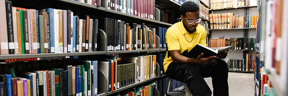 McKenna school student in the library stacks