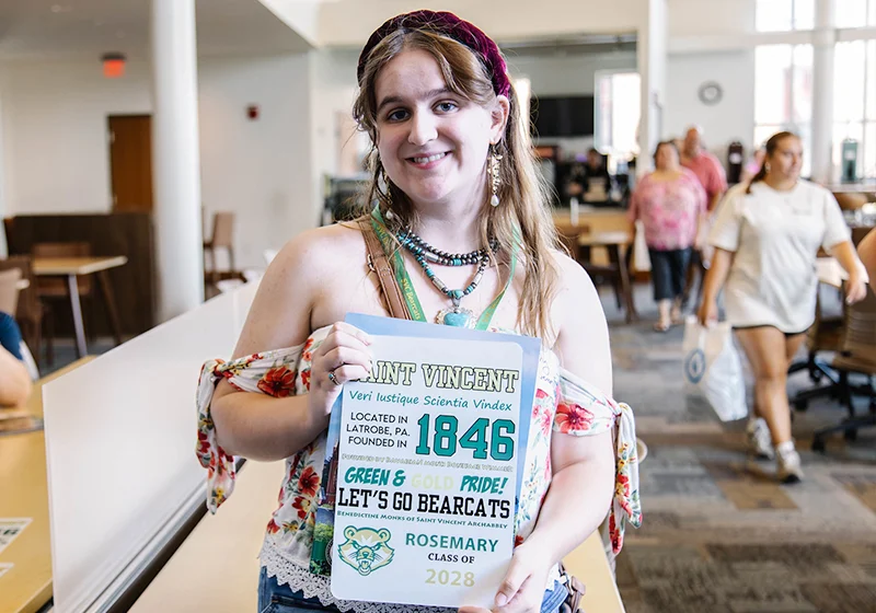 A student holds a sign representing Saint Vincent University, showcasing school pride and the founding year 1846.