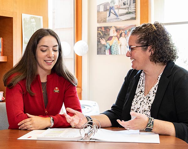 student and school associate looking at paperwork