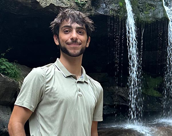 Brandon Karafilis at Fallingwater outdoors with waterfall in the background