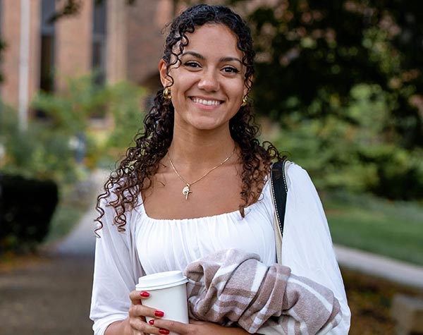 Student Portrait of Natalie Homison outside with fall leaves in the background