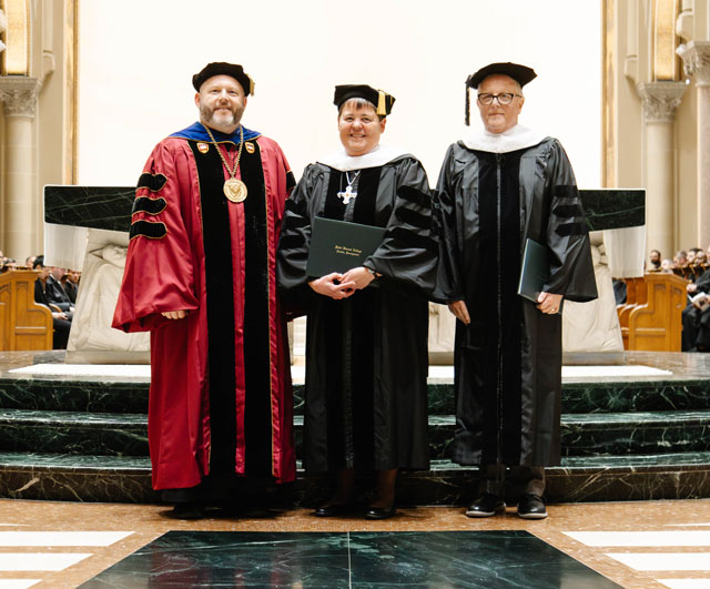 Father Paul Taylor, Sister Nicole Kunze, and William G. Laird, standing together for a photo at the Saint Vincent Basilica during the College’s Founders’ Day Honors Convocation.