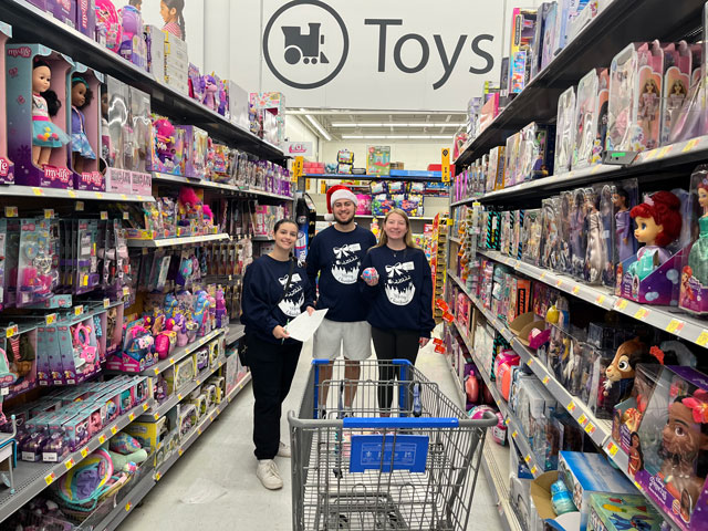 Saint Vincent College students shopping for SVC Wraps in the toy section of Walmart