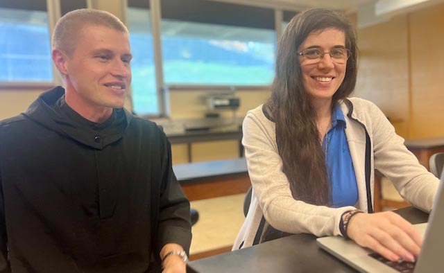 Photo of Fr. Michael Antonacci and Dr. Mary Regina Boland working at a computer