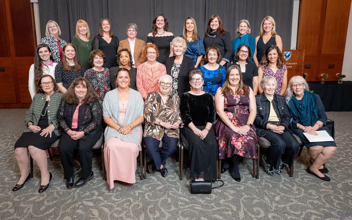 A group photo featuring a diverse group of women in formal attire, gathered together for an event. The setting appears to be a professional venue, showcasing a sense of celebration and camaraderie.