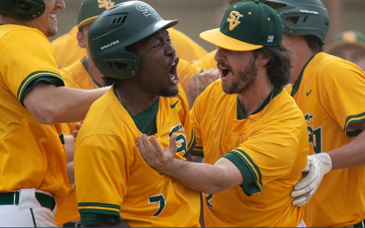 Team members celebrating a baseball victory, showcasing excitement and camaraderie in their bright yellow and green uniforms.