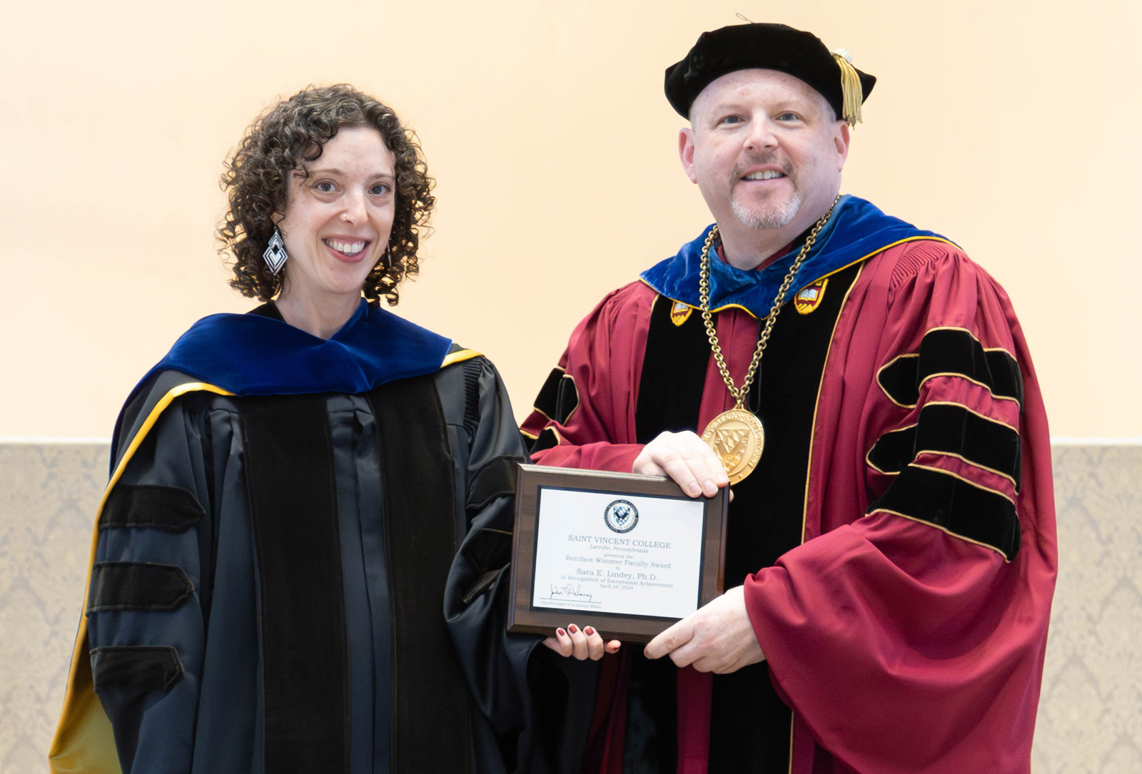 Dr. Sara Lindey and Father Paul posing with the Boniface Wimmer Faculty Award on Wednesday during the 2024 Saint Vincent College Spring Honors Convocation.