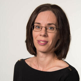 Portrait photo of Dr. Mary Beth Yount, brown hair and glasses, wearing a black top.