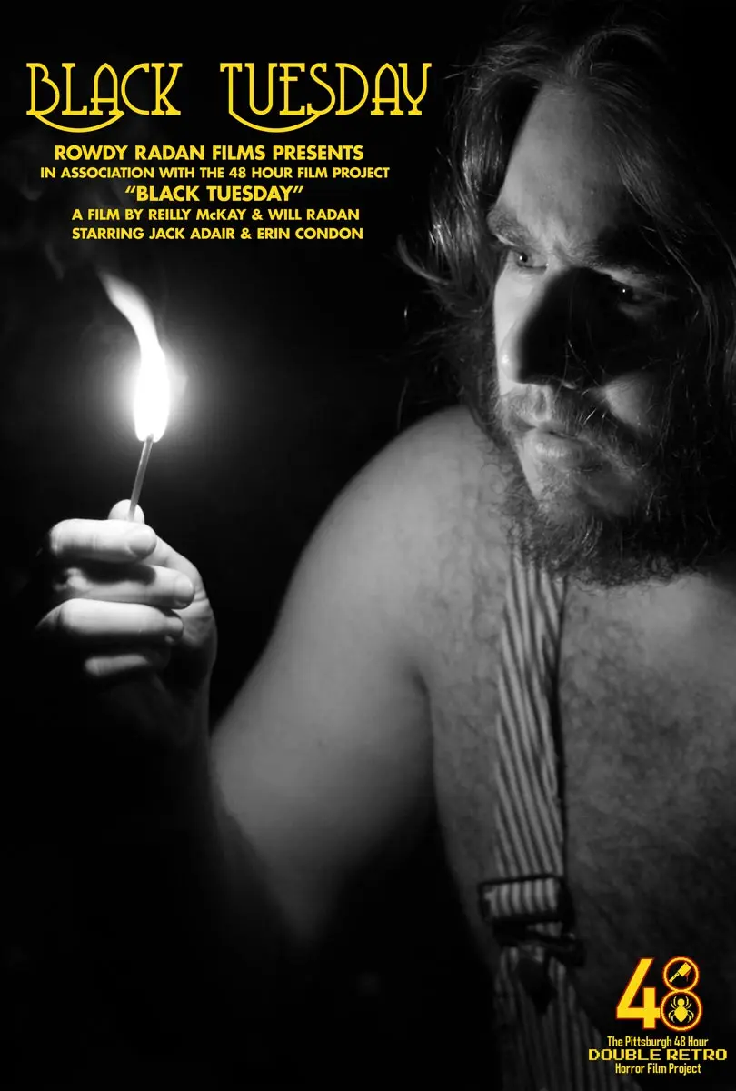 Promotional poster for the short film "Black Tuesday," featuring a dramatic black-and-white portrait of a man with long hair, illuminated by candlelight, creating a mysterious atmosphere.