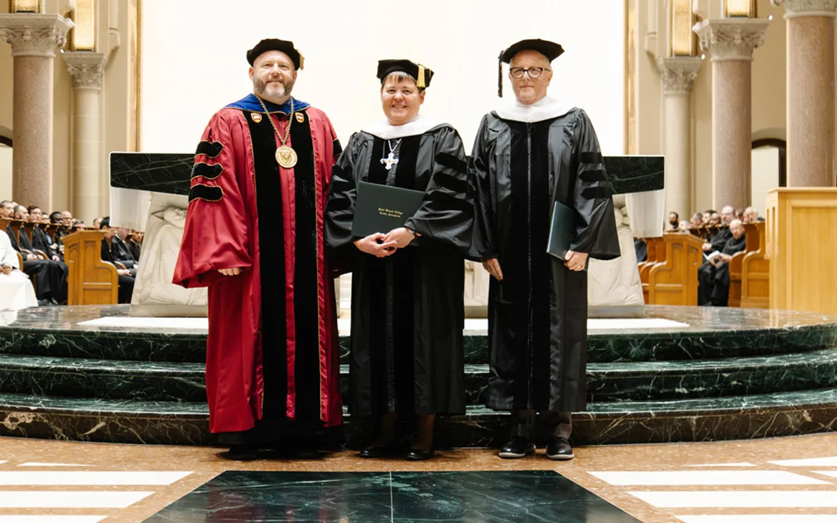 Father Paul Taylor, Sister Nicole Kunze, and William G. Laird, standing together for a photo at the Saint Vincent Basilica during the College’s Founders’ Day Honors Convocation.