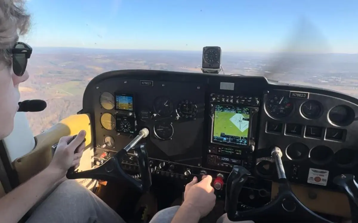 Photo of Nicholas Sikorski in the cockpit piloting a Cessna 172 Skyhawk