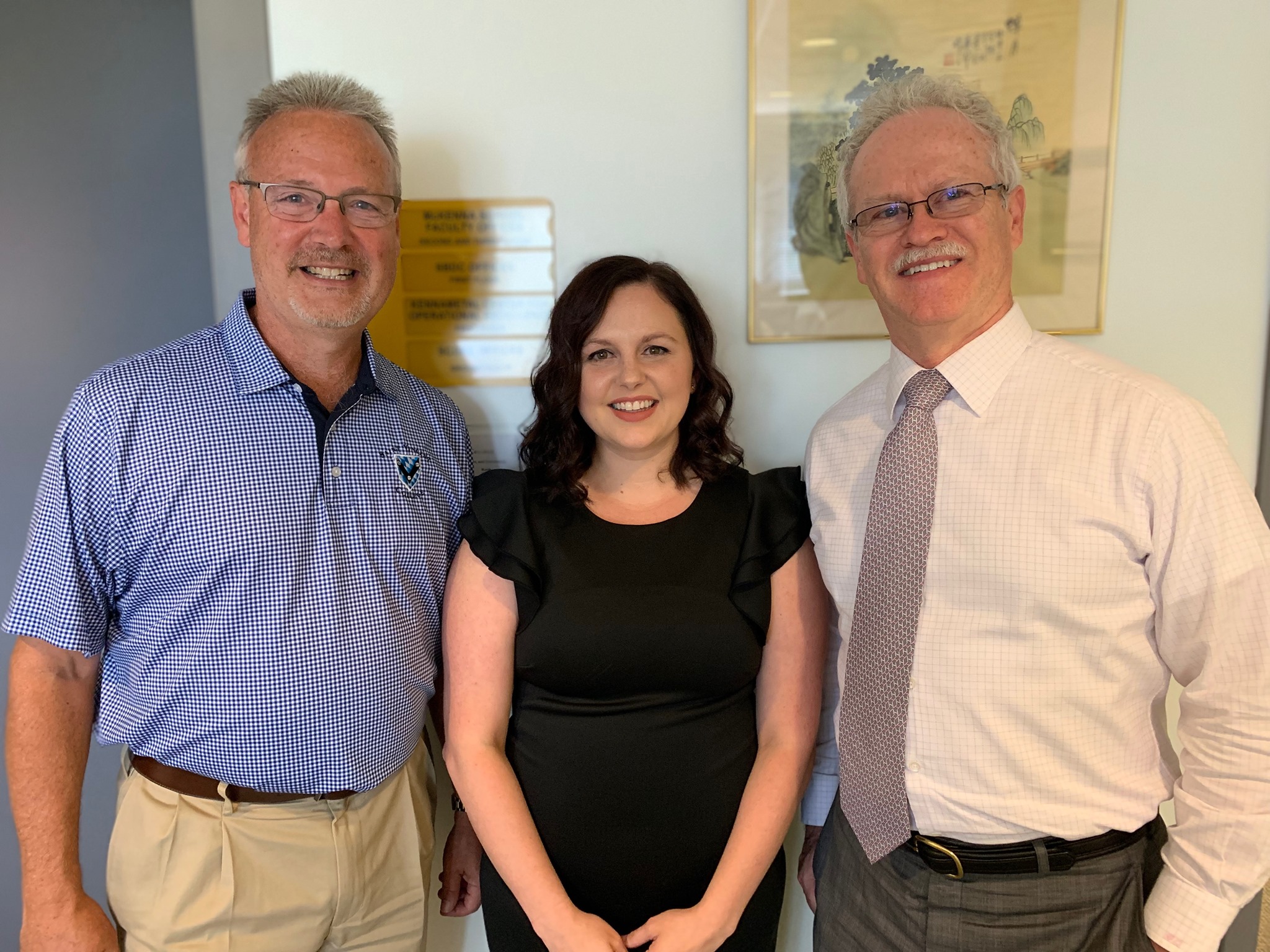    PHOTO: Briana Baum with instructor of business administration Robert Markley and former dean of the McKenna School Dr. Gary Quinlivan